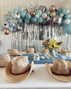 a table topped with hats and balloons