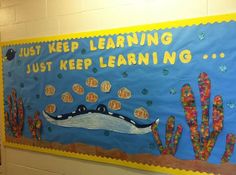 a bulletin board with an image of a crocodile on it and words that read just keep learning, just keep learning