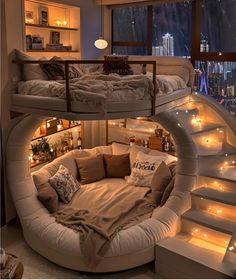 a spiral bed is in the middle of a room with stairs and lights around it