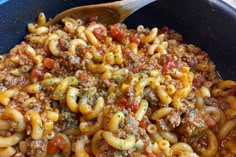 a skillet filled with pasta and meat