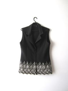 "Vintage Elegant Women's Black Vest Embroidered Flowers Vest Size Medium Secretary Waistcoat Black Long Vest Estimated size: M Measurements: (lying flat) Length - 27\" / 68.5 cm Pit to pit: 18.5\" / 47 cm Waist - 16.5\" / 42 cm Please check measurements to insure a proper fit. Remember to allow yourself some extra room for movement. You can compare these with something from your closet that fits you well. This vest will come to you freshly laundered and ready to wear. Please feel free contact me Elegant Embroidered Fitted Vest, Elegant Fitted Embroidered Vest, Fitted Sleeveless Outerwear With Floral Embroidery, Fitted Sleeveless Floral Embroidered Outerwear, Womens Black Vest, Gilet Long, Long Vests, Black Vest, Vintage Elegant