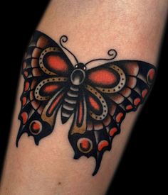 a tattoo with a butterfly on it's arm and the words cobra tattoo madrid