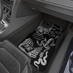 the interior of a car with black and white drawings on it's floor mats