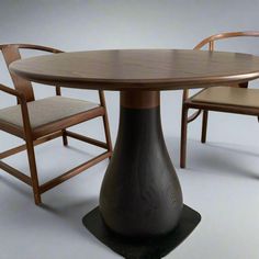 a wooden table with chairs around it and an oval shaped dining table in the middle