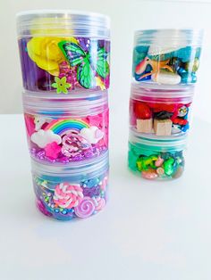 plastic containers filled with lots of different types of candies and candys on top of a white table