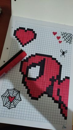 a cross stitch pattern with a spiderman drawn on it and a crayon marker next to it