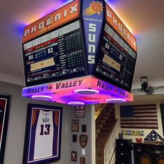 the inside of a sports shop with scoreboards on the ceiling and pictures hanging from the ceiling