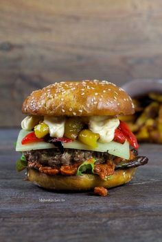 a hamburger with vegetables and cheese on it