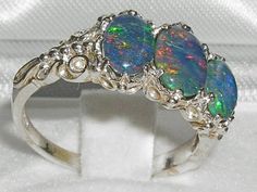 *This 3 stone ring is made from 925 Sterling Silver with Opal Triplets.This is an English Made beautiful ring set with one Center 8x6 mm (0.32" x 0.24") and two 7x5 mm (0.28" x 0.20") beautiful oval cut Large Opal Triplets set in a Pure Solid 925 Sterling Silver Antique / Victorian style setting. This ring has a good solid feel, a nice weight and a good thick shank.*Total Height 5mm, Width 16mm, Length 11mm Completely made from Solid English Sterling Silver Hallmarked by the London Assay Office Classic Three Stone Oval Opal Ring, Oval Three-stone Opal Ring, Oval Three Stone Opal Ring, Oval Three Stone Sterling Silver Jewelry, Oval Three Stone Opal Ring For Anniversary, Silver Three Stone Opal Ring, Silver Three Stone Opal Ring For Anniversary, Oval Three Stone Opal Promise Ring, Victorian Style Rings