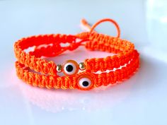 "Orange evil eye with neon orange braided macramé bracelet and accented with gold-filled beads in sizes for women's men and kids, Custom-made to your own wrist size, Bracelet is safe to get wet, Bracelet is 5mm wide and Eye bead is 8.5 mm A pretty bright orange color string with a glass orange evil eye amulet for a little more protection and good luck 𝗛𝗮𝗻𝗱𝗺𝗮𝗱𝗲 𝗴𝗶𝗳𝘁  A lovely Handmade-orange-jewelry-gift for you and loved ones  Custom made by hand with Love and care in our workshop Re Orange Evil Eye Bracelet, Adjustable Orange Bohemian Braided Bracelet, Orange Bohemian Braided Bracelets For Friendship, Handmade Orange Braided Bracelets In Bohemian Style, Orange Handmade Bohemian Braided Bracelets, Handmade Bohemian Orange Braided Bracelet, Handmade Orange Bohemian Braided Bracelet, Orange Bohemian Friendship Bracelets As Gifts, Orange Bohemian Friendship Bracelets Gift