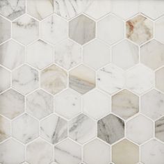 a white marble tile with hexagons on it