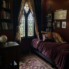 a bed sitting in front of a window next to a book shelf filled with books