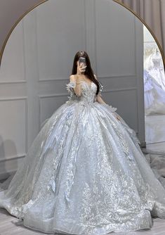 a woman in a ball gown is taking a selfie