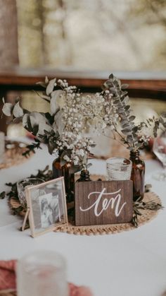 the table is set with flowers and photos