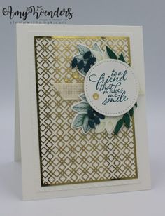 a close up of a greeting card with flowers on the front and bottom, in gold foil