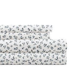 the sheet set is white with black and blue flowers on it, along with two matching sheets