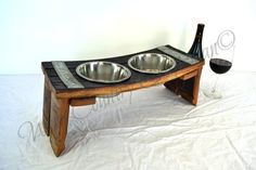 a wooden table with two bowls on it and a wine glass sitting next to it