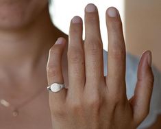 Sterling silver signet ring for women, minimalist custom engraved initials pinky ring.This simple and dainty signet ring is made of sterling silver. It will be especially beautiful as a pinky ring will look great on any finger you choose to wear it. The ring is not hollowed and has a shiny finish, also on the inside. This ring can be customized: It can be hand engraved to up to 3 letters. The engraving can be made with a font of your choosing - you can even write it in your own handwriting.Nothi Minimalist Signet Ring With Polished Finish, Adjustable Oval Dome Ring Minimalist Style, Silver Oval Initial Ring Fine Jewelry, Silver Oval Initial Ring In Fine Jewelry Style, Modern Adjustable Signet Ring, Dainty Adjustable Signet Ring, Adjustable Polished Signet Ring, Minimalist White Gold Signet Ring For Anniversary, Minimalist White Gold Engraved Ring With Polished Finish