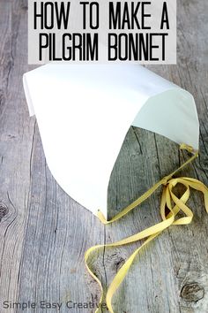 a white paper umbrella sitting on top of a wooden floor next to a yellow ribbon