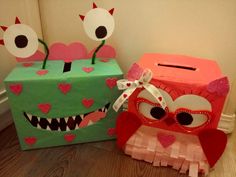 two boxes that have been decorated to look like monsters with hearts on their eyes and mouths