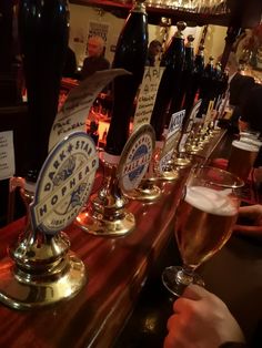 a row of beer glasses sitting on top of a bar