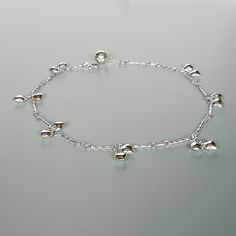 Sterling silver speciality chain anklet. Comes with tiny puffed heart charms. Also ends with a tiny bell. Length: 10 inches. Hearts : 5 x 6 mm Bell: 7mm Price listed is for ONE piece. These anklets are made of 925 hypoallergenic sterling silver. All my pieces are sent in a gift box. I can include a personal message from you if needed. You are welcome to contact me at... bhavnakwintra1956@gmail.com For more beautiful pieces from my shop, please browse 👇 TOE RINGS: https://www.etsy.com/your/shops Dainty Sterling Silver Anklets, Elegant Silver Anklets With Heart Charm, Dainty Silver Heart Anklets, Silver Chain Anklet, Anklet Silver, Foot Chain, Wanderlust Jewelry, Silver Anklet, Ankle Chain