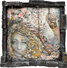 an altered photograph of a woman's face in a stone frame with flowers on it