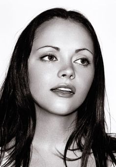 a black and white photo of a woman with long hair