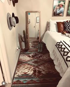 a bed room with a neatly made bed and pictures on the wall