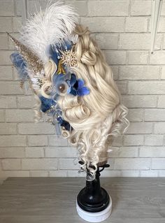 This extravagant wig is 24" tall for sky-high drama. accessories can be customized to suit your specific look. This exquisite wig features pilled tall white hair, adorned with decorative feathers and flowers for an authentic antique look. The lace hairline adds a touch of realism, while the voluminous style ensures a head-turning presence. This wig offers stability due to its wig cage for long lasting style. Decorative Feathers, Ice Fairy, Drag Wigs, Wig Party, Party Inspo, Unique Hairstyles, Fan Girl, Book Decor, Sky High