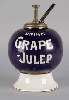 a blue and white ceramic jug with a drink in it that says grape - julep