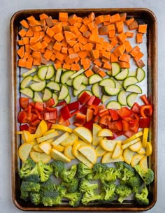 vegetables cut up and arranged on a baking sheet to make a rainbow vegetable platter