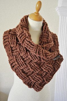 a brown knitted scarf on top of a white mannequin