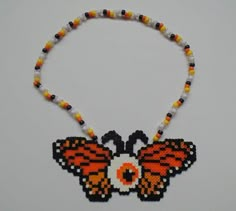 a beaded necklace with an orange and black butterfly on it's back end