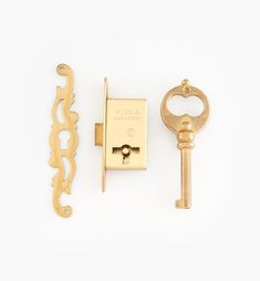 two keys and a key lock on a white surface