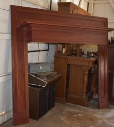 an old fireplace in a room with wood trimming