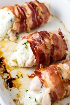 bacon wrapped in cream cheese and garnished with parsley on a white plate