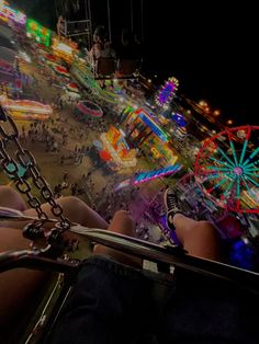 people are riding on a carnival ride at night