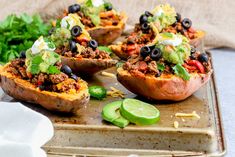 stuffed sweet potatoes topped with taco meat and black olives