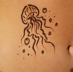 a woman's stomach with a tattoo design on the side of her body, depicting a jellyfish and bubbles