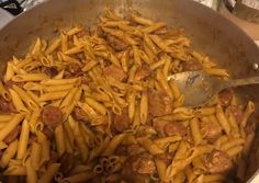 a pan filled with pasta and meat on top of a stove