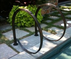 there is a metal bike rack next to the pool