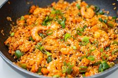 a skillet filled with shrimp and rice