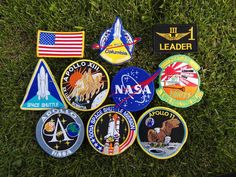 several nasa patches laying in the grass