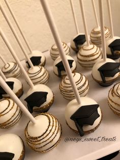 white and black cupcakes with graduation caps on them