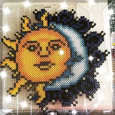 an image of the sun and moon made out of perler beads on a wall