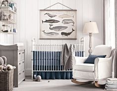 a baby's room is decorated in white and blue