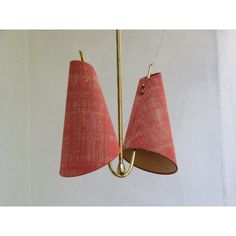 two red lamps hanging from the ceiling in a room