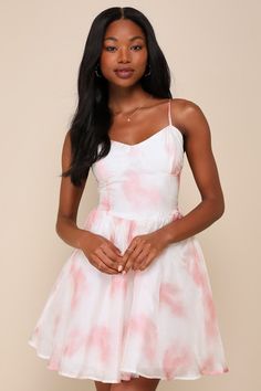 Get ready to charm your way through every event in the Lulus Exceedingly Adorable Ivory and Pink Chiffon Bustier Mini Dress! Sleek, lightweight woven chiffon boasts an artistic pattern of pink and white (with an ultra-subtle rose print running throughout) as it shapes adjustable spaghetti straps and a sweetheart neckline. Bustier-style bodice has seamed cups and a high, fitted waist. Skirt has a ballroom-ready, skater silhouette, with a hidden layer of tulle for volume and a mini hem. Smocked pa