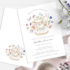 a wedding card with a teacup and flowers on it next to a cup of coffee